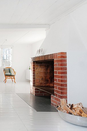 Scandinavian Interior wirh red brick fireplace